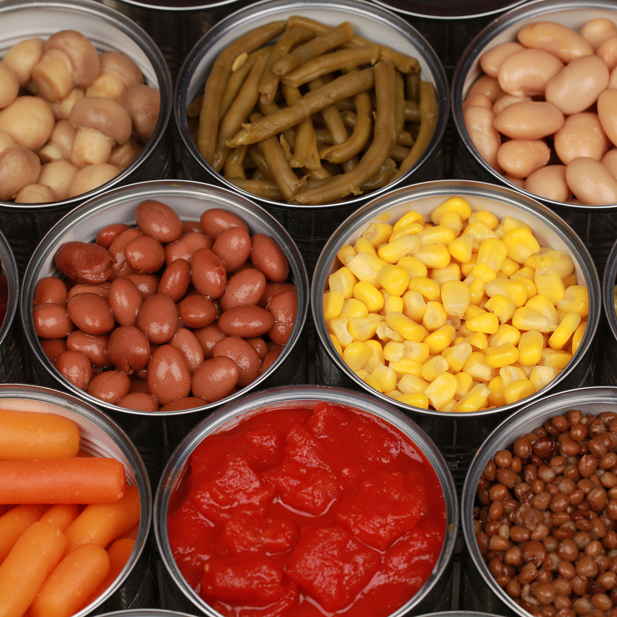 a-group-of-opened-cans-of-food-containing-fruits-vegetables-and-legumes